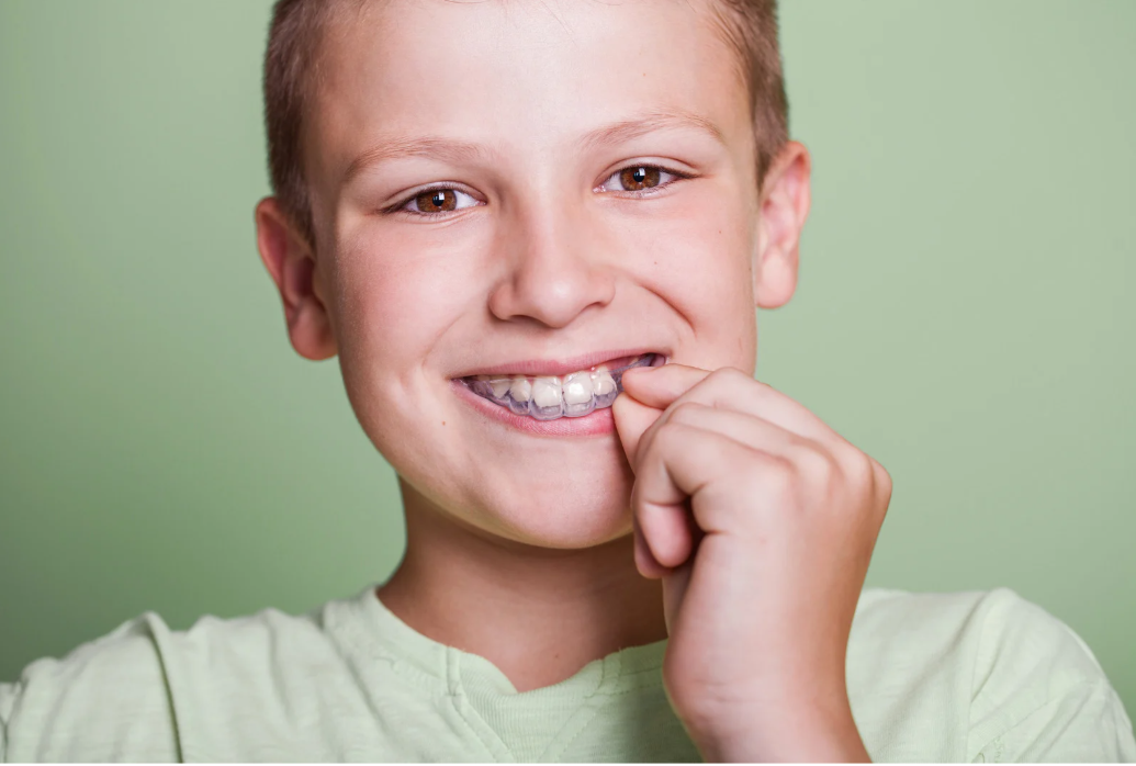 boy wearing custom mouthguard for sports protection at pediatric dentist in Bedminster